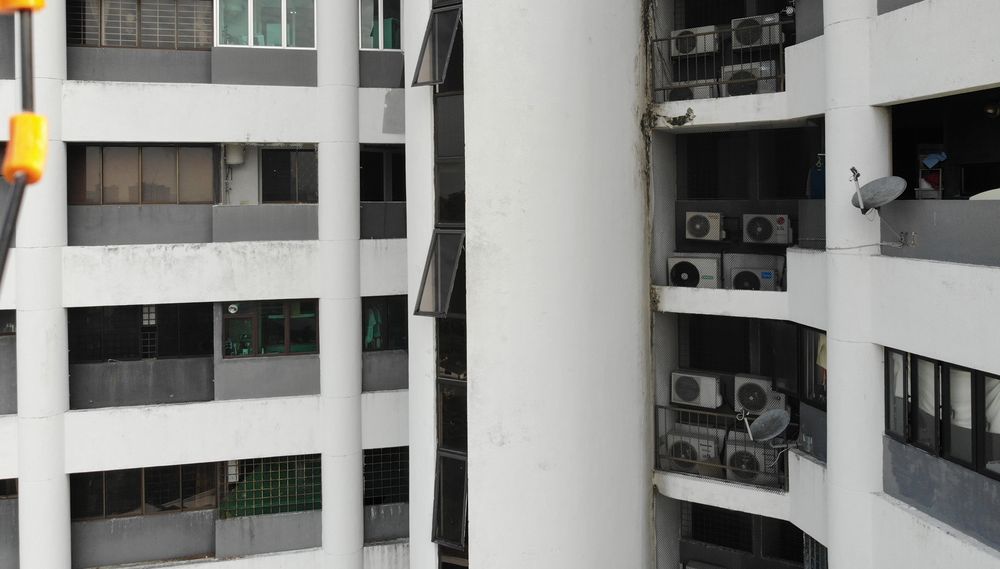 Drone view of a high-rise facade during inspection